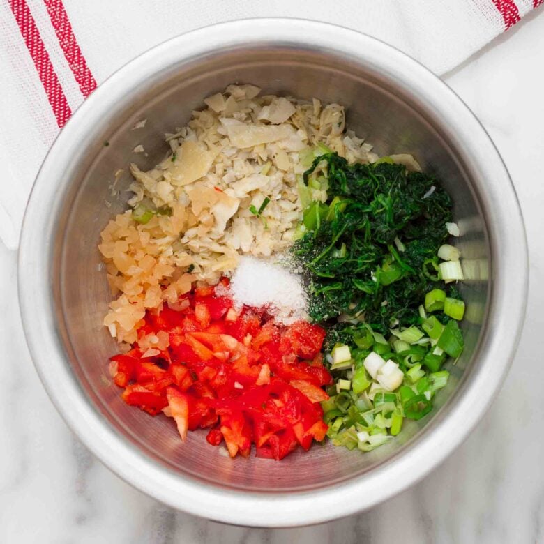 Ingredients to make spinach artichoke dip without mayo in a bowl.