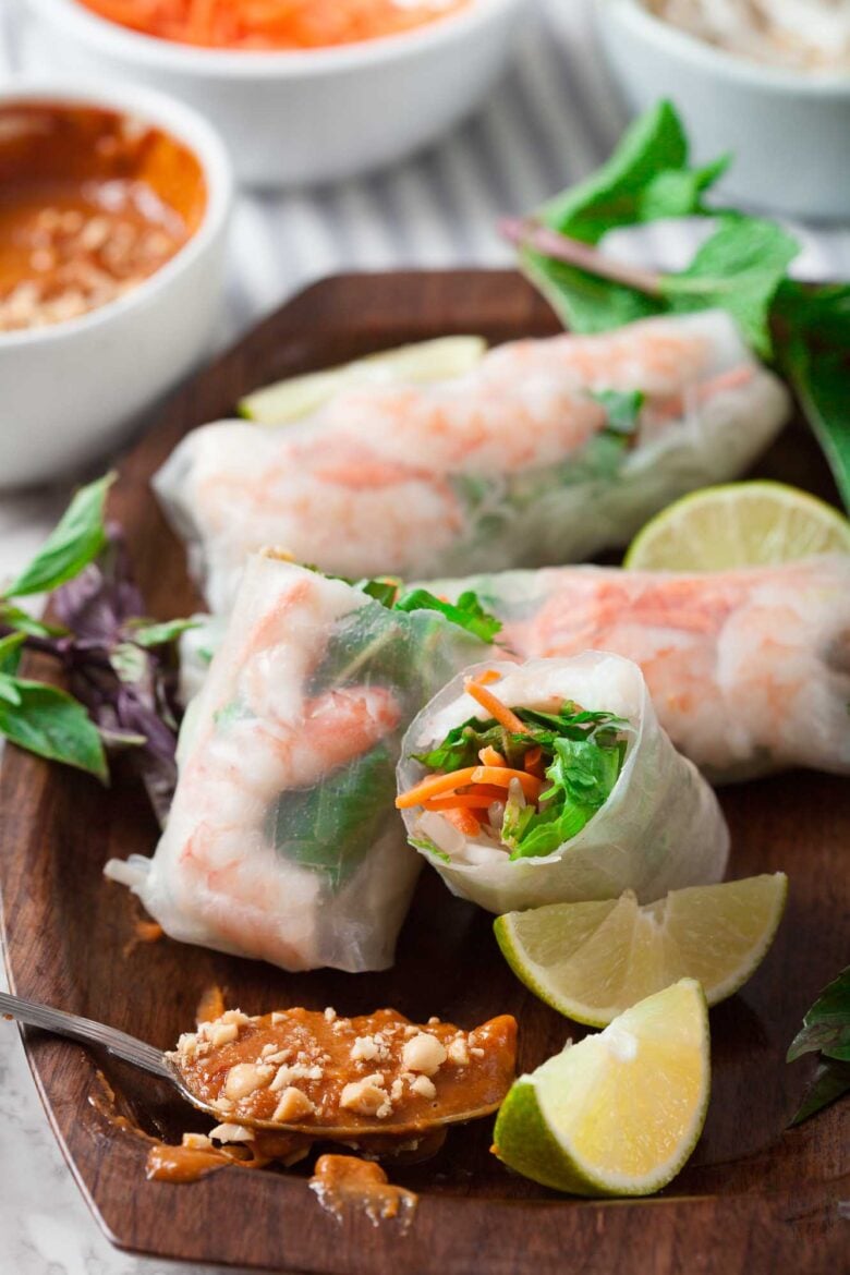 Vietnamese spring rolls with julienned carrots and fresh veggies visible inside.