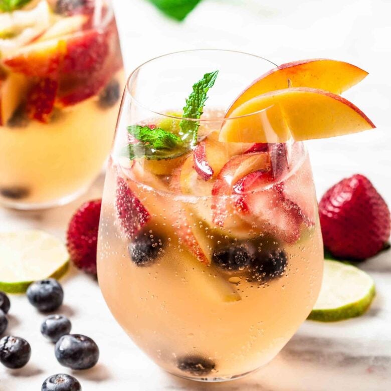 Summer sangria with strawberries, blueberries, and peaches.