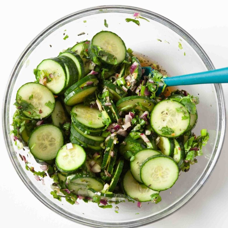 Asian cucumber salad tossed with dressing and ready to serve.