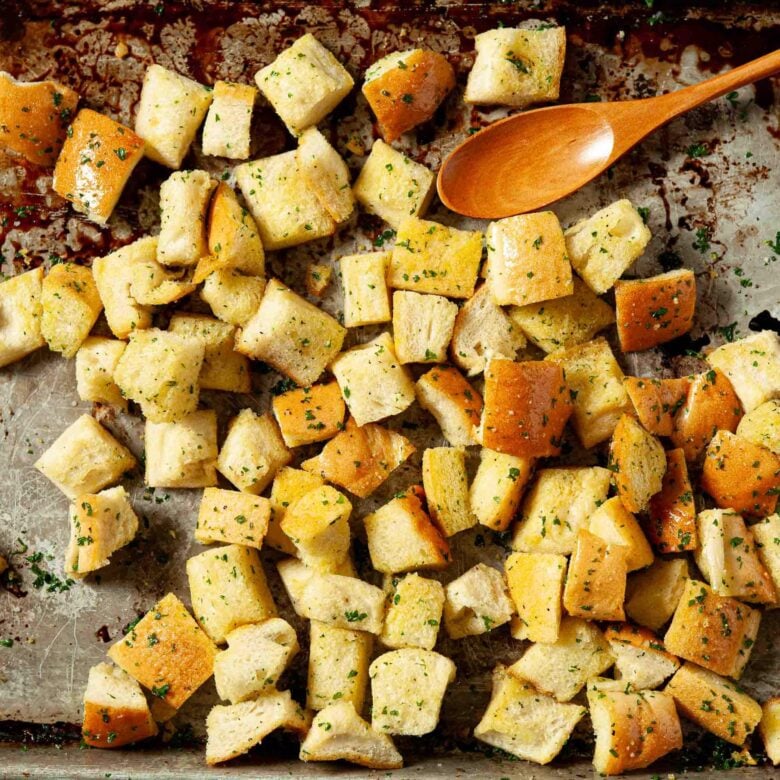 Garlic croutons on a baking sheet, bread to be baked.