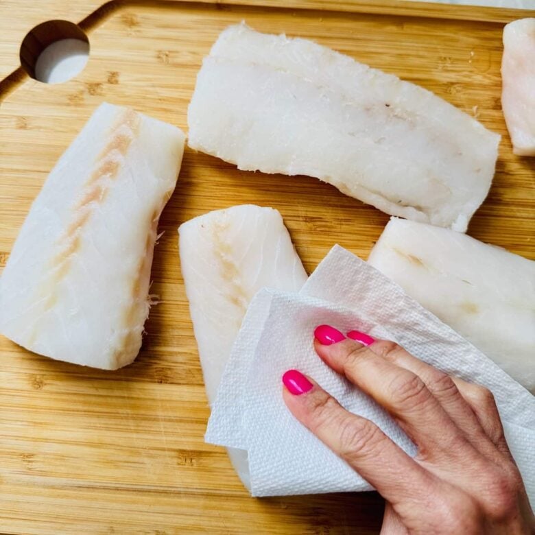 Rockfish fillets being patted dry.