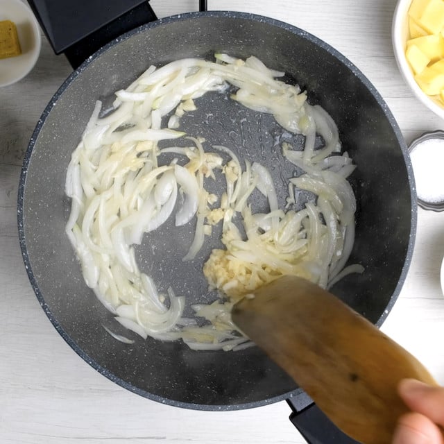 Onion and garlic being sautéed in a pan to make Japanese chicken curry.