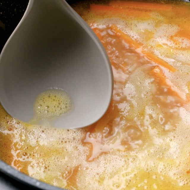 Japanese chicken curry broth being skimmed.