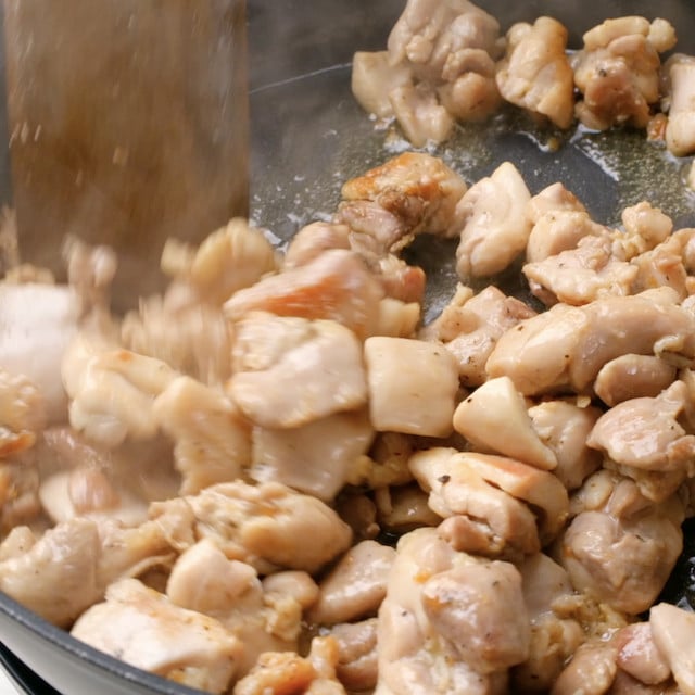 Chicken being cooked in a pan to make Japanese chicken curry.