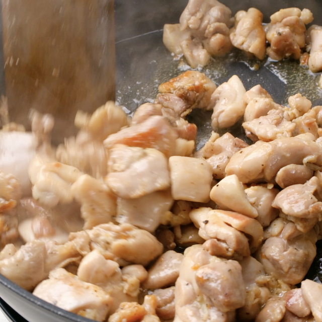 Chicken being cooked in a pan to make Japanese chicken curry.