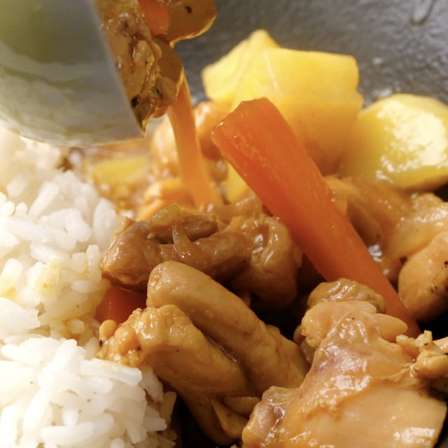 Japanese chicken curry being served over rice.