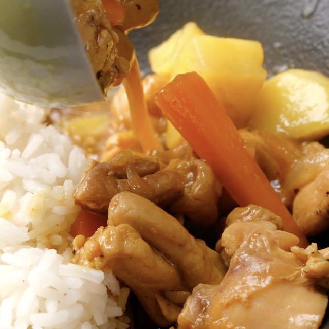 Japanese chicken curry being served over rice.