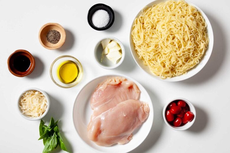 Overhead shot of ingredients to make bruschetta chicken pasta at home.