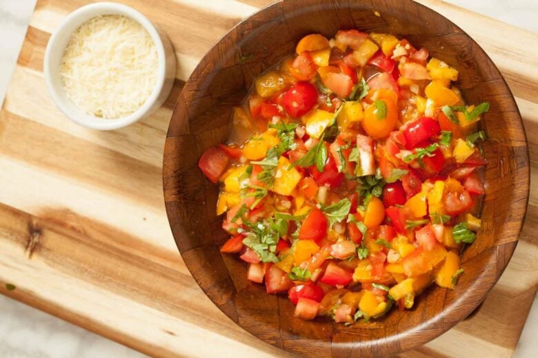Overhead shot of ingredients to make fresh tomato basil pasta at home.