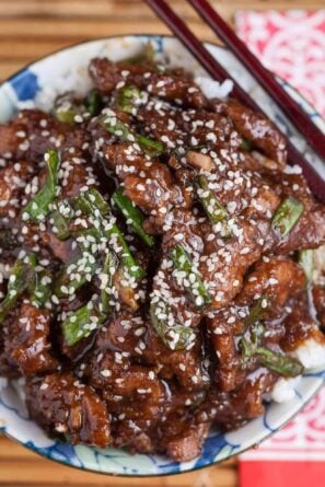 Overhead shot of a bowl with homemade Mongolian beef recipe with sesame seeds on top.