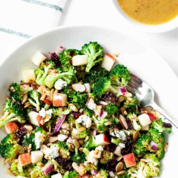 Overhead shot of homemade broccoli apple salad in a white dish.