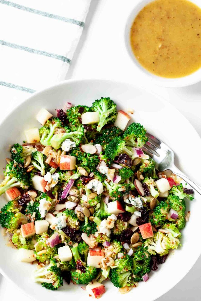 Overhead shot of homemade broccoli apple salad in a white dish.