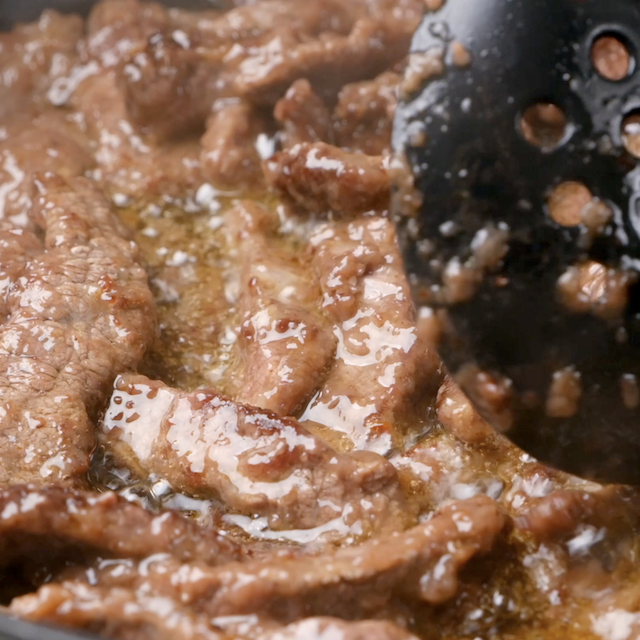 Beef being browned on all sides in a pan to make Monglian beef recipe.