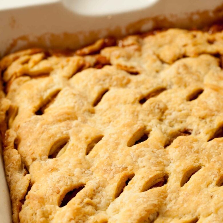 A closeup shot of apple pie bar with slits.