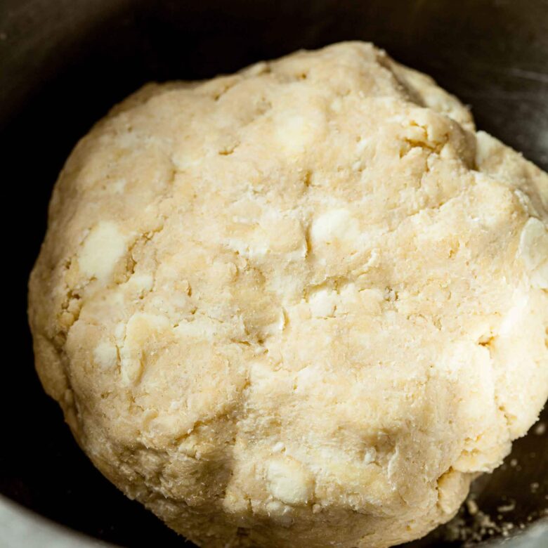 Dough to make apple pie bars in a bowl.
