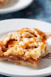 Closeup shot of a apple pie bar, drizzled with homemade salted caramel sauce.