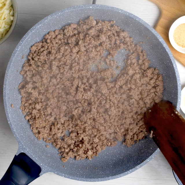 Sausage being browned in a pan to make baked rigatoni.