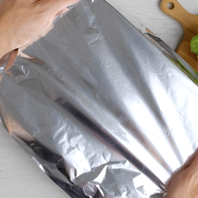 Foil being added over casserole.