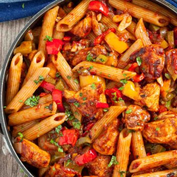 A skillet filled with Chicken Fajita Pasta all prepared as a one-pan quick meal and garnished with fresh herbs.