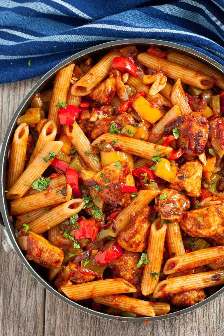 A skillet filled with Chicken Fajita Pasta all prepared as a one-pan quick meal and garnished with fresh herbs.
