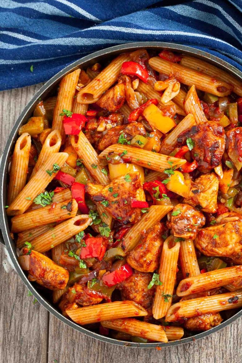 A skillet filled with Chicken Fajita Pasta all prepared as a one-pan quick meal and garnished with fresh herbs.