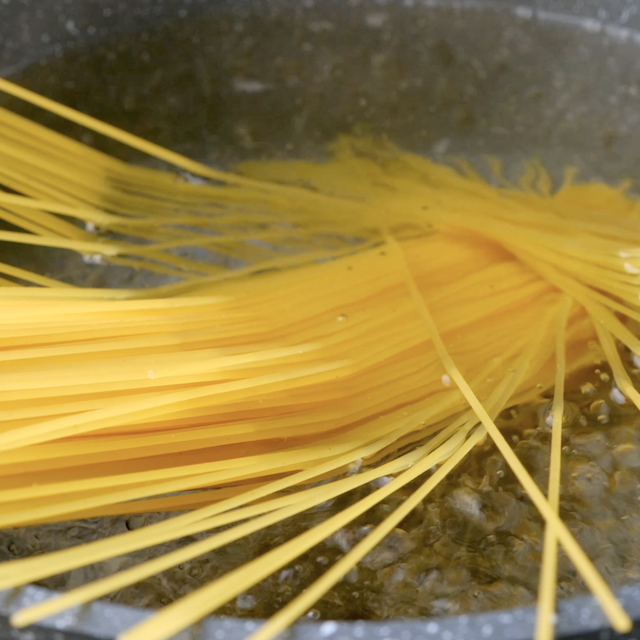 Noodles being boiled to make lo mein noodles at home.