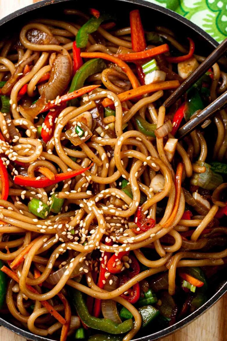 Overhead shot of homemade lo mein noodles, garnished with sesame seeds.