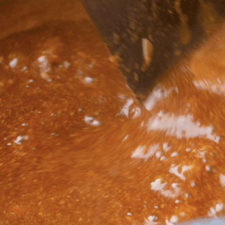 Peanut sauce for soba noodles being whisked in a pan.