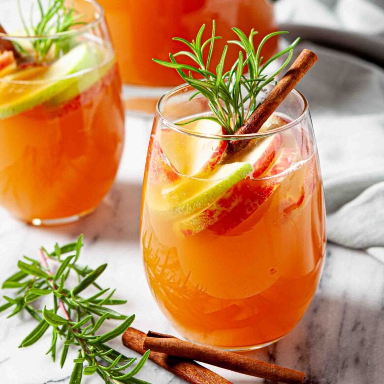 apple sangria with apple cider and slices of apples in a glass. 