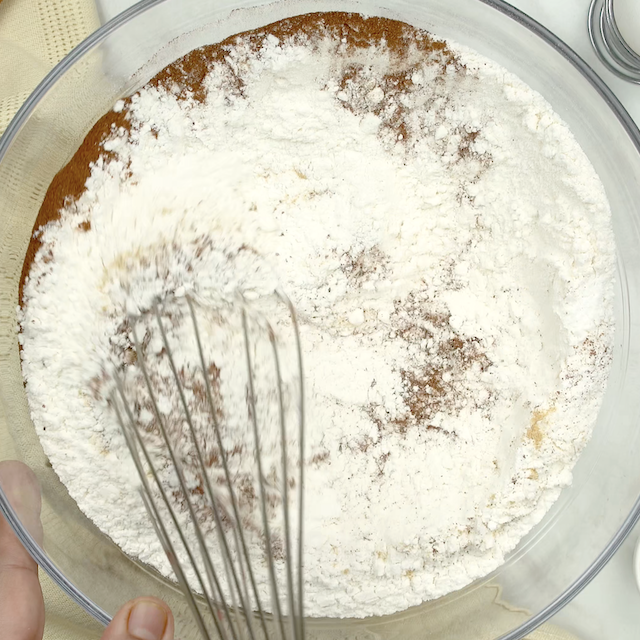 Dry ingredients being whisked together to make pumpkin donut holes.