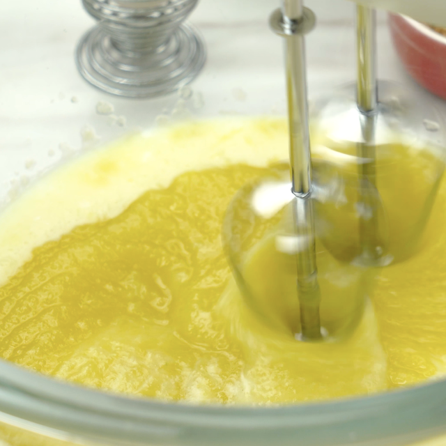 Pumpkin puree being whisked into buttermilk to make pumpkin donut holes.
