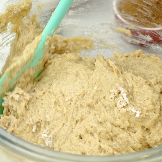 Flour being folded into pumpkin mixture to make pumpkin donut holes at home.