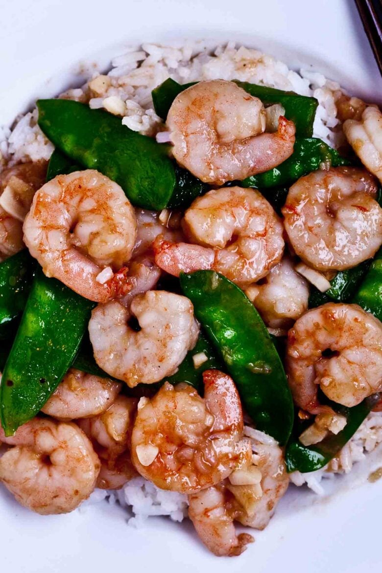Closeup shot of homemade shrimp with snow peas, served over jasmine rice.