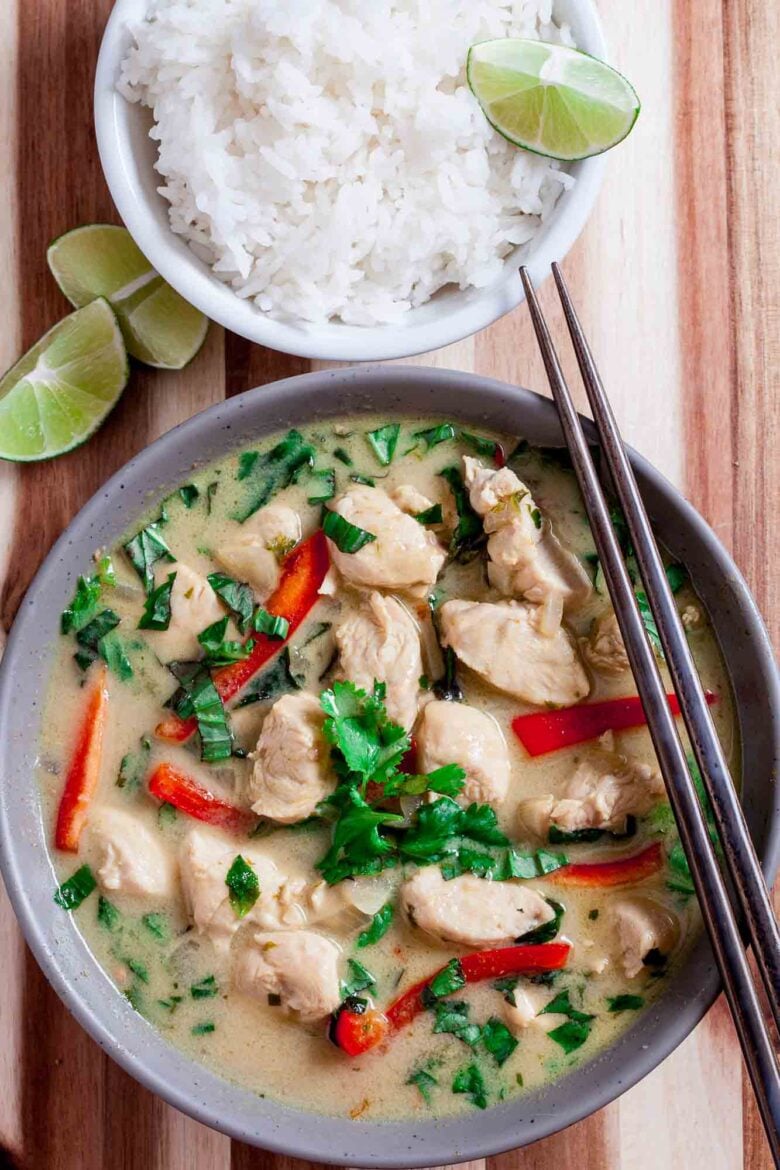 Overhead shot of a bowl with thai chicken curry, with chopsticks on the side.