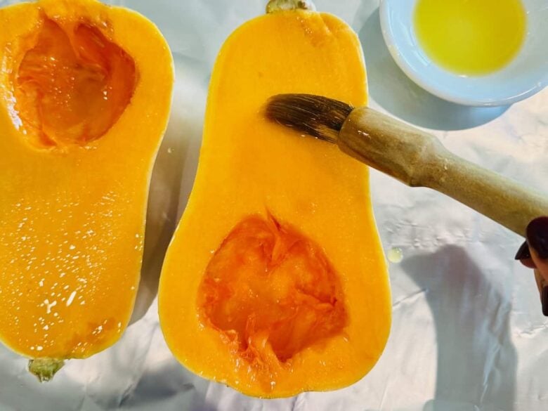 Butternut squash being brushed with oil.