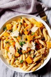 Overhead shot of a bowl with homemade butternut squash pasta with a fork on the side.