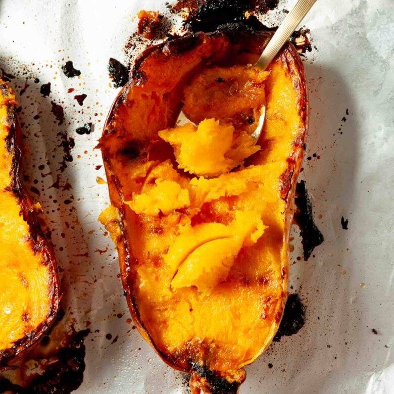 Roasted butternut squash being scooped.