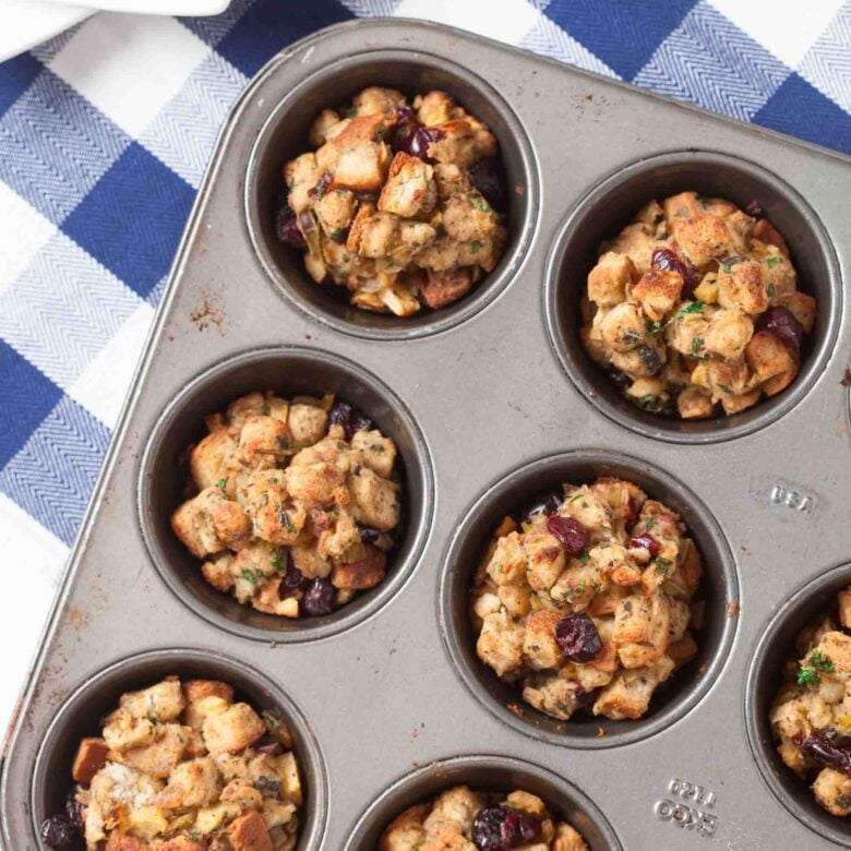 Overhead shot of stuffing muffins in a muffin tin.