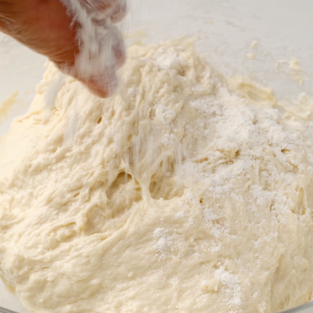 Flour being added to dough.