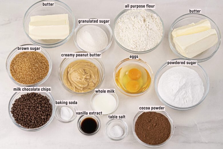 Ingredients to make peanut butter fudge cookies on a marbled surface.