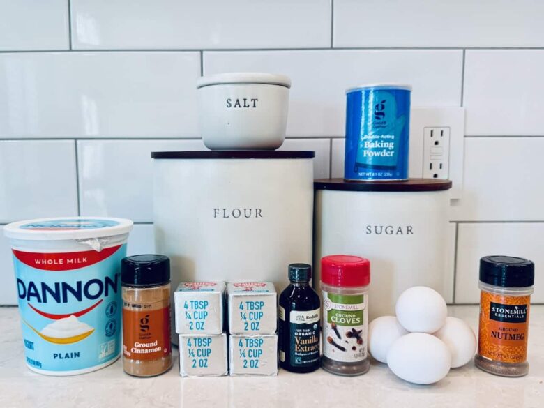 Ingredients to make snickerdoodle bread on a white kitchen counter.