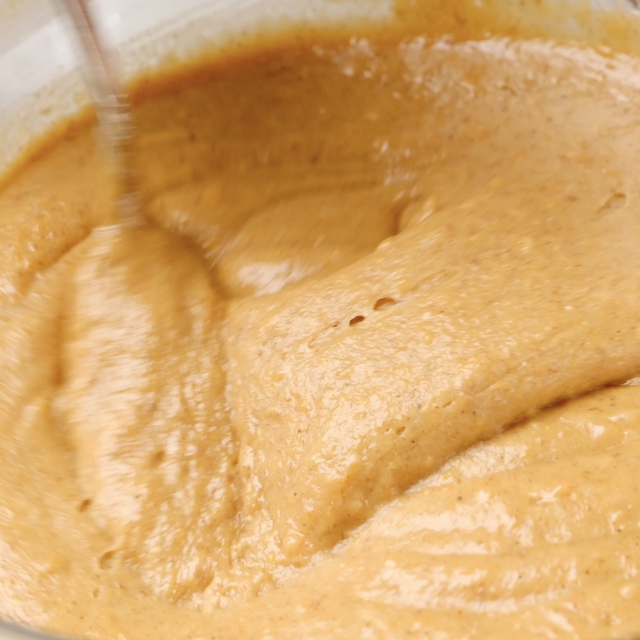 Dry ingredients being mixed into sweet potato muffins batter.