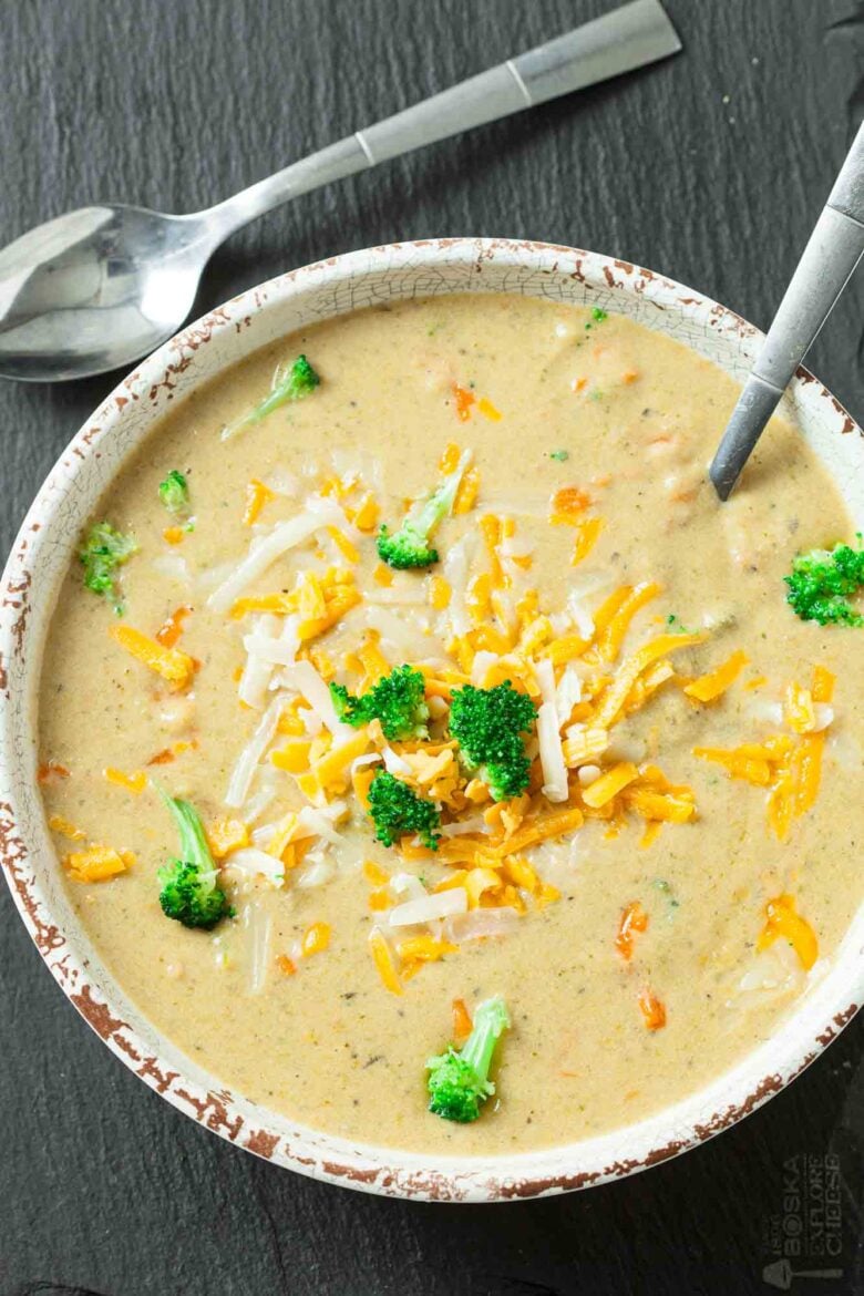 Overhead shot of a bowl of broccoli cheese soup with a spoon.