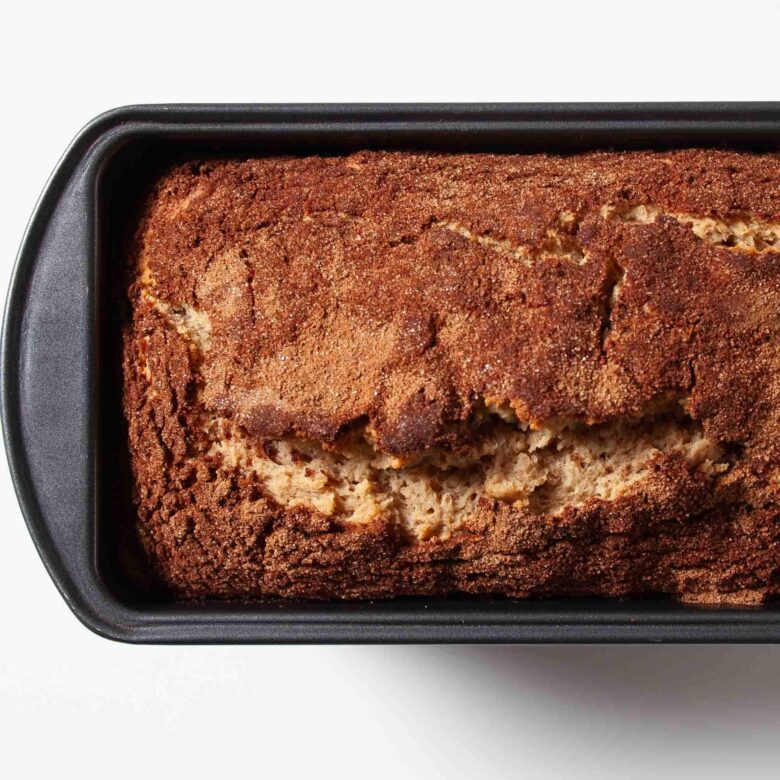 Freshly baked snickerdoodle bread in a loaf pan.