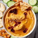 Overhead shot of sweet potato hummus with sesame seeds on top.