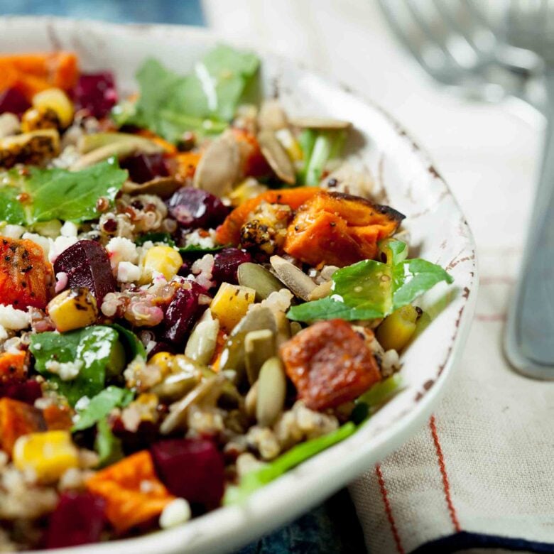 Closeup shot of sweet potato quinoa salad with roasted sweet potatoes, beets, and fire roasted corn.