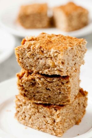 Closeup shot of three stacked apple oatmeal bars.