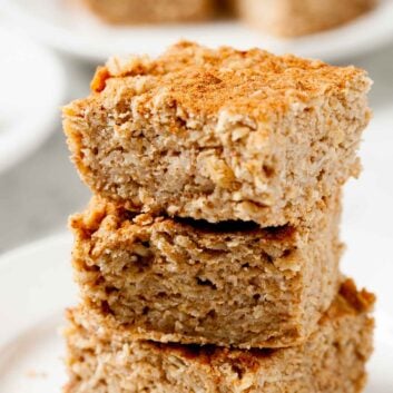 Closeup shot of three stacked apple oatmeal bars.