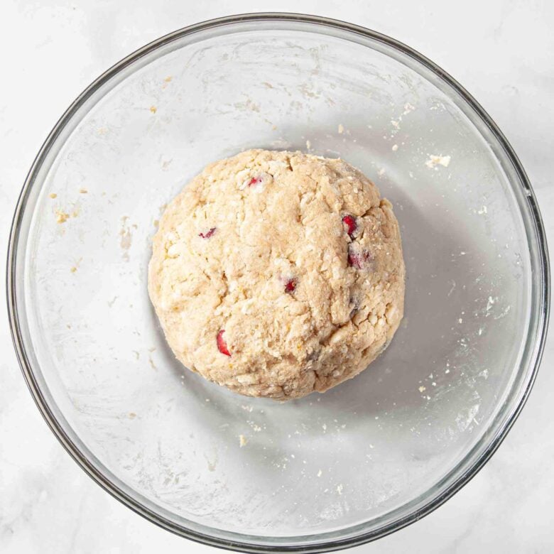 A ball of cranberry orange scones in a glass bowl.